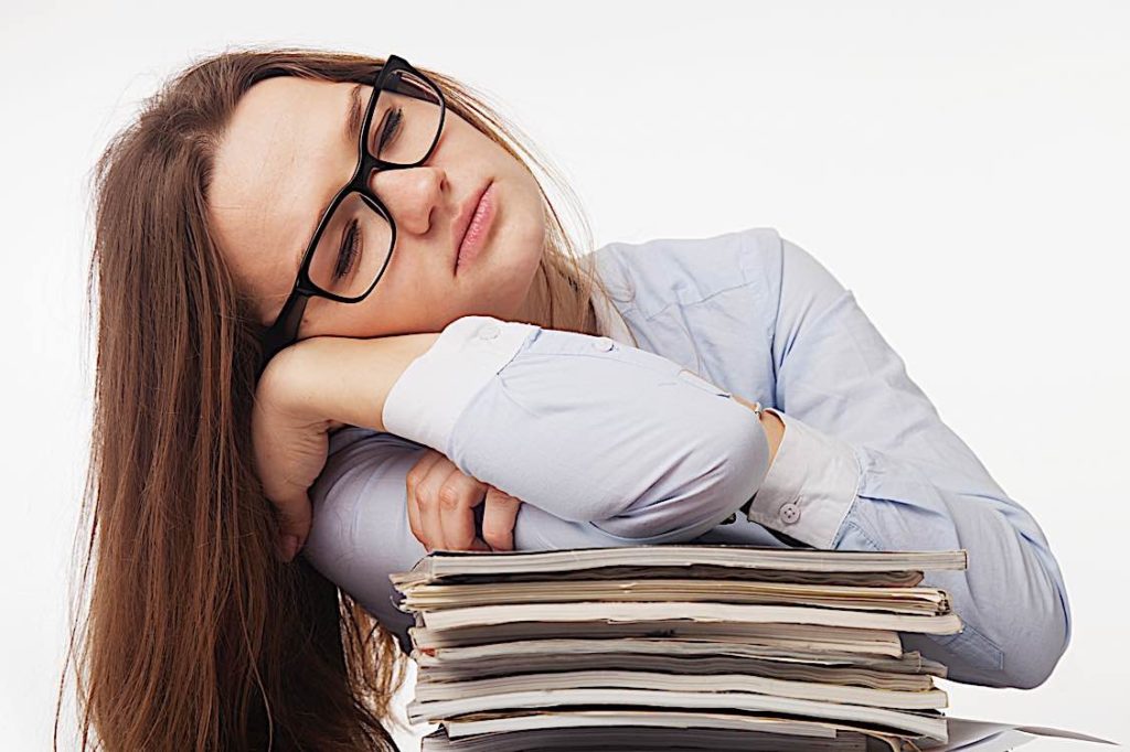 "Dying for a paycheque?" — good HR Managmement can breathe new life into your team 4 Overworked sleeping on pile of work Pivotal HR Solutions Blog