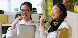 Two women laughing in office