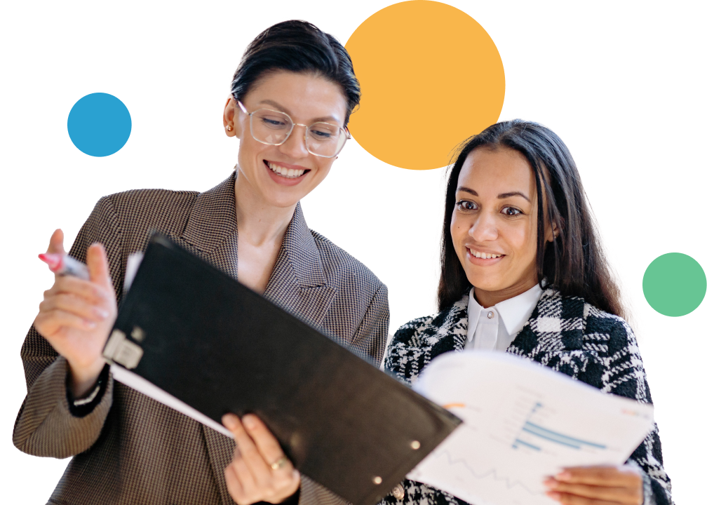 Two women looking at clipboard.