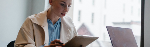 Product Reference Check Woman looking at clipboard