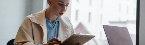 Woman looking at clipboard