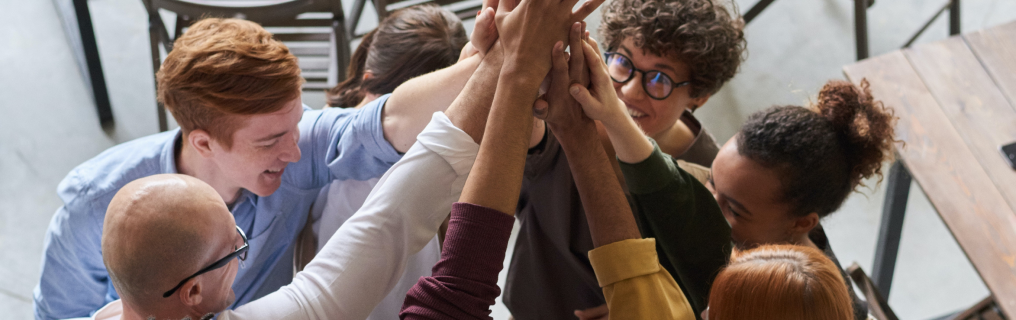 Co-workers high-fiving in celebration.